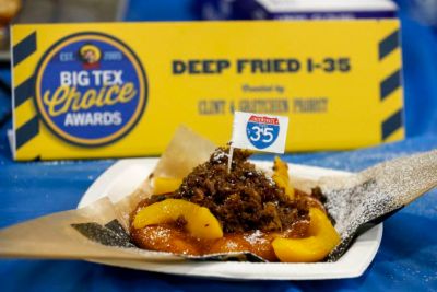 A kolache topped with smoked brisket, peaches and a Dr Pepper barbecue sauce