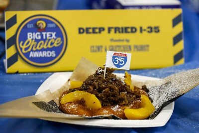 A kolache topped with smoked brisket, peaches and a Dr Pepper barbecue sauce