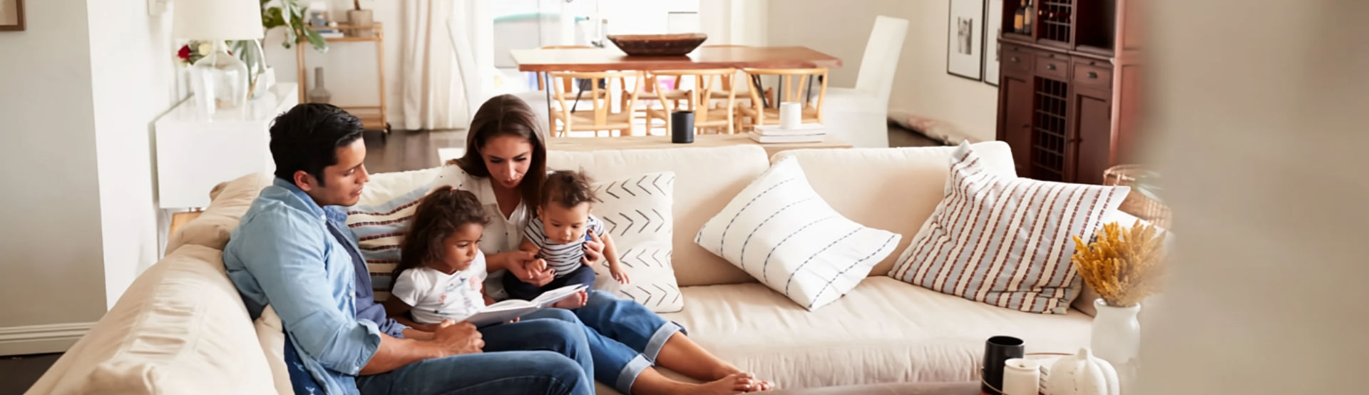 A family sitting on a couch in a living room