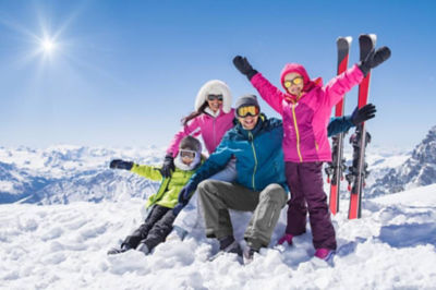 Happy family in snow during ski trip
