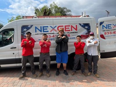 Five employees standing in front of a NexGen Truck