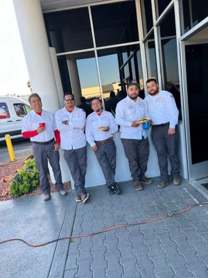 Five Techs standing outside of a building