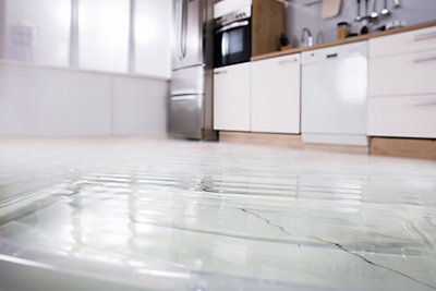 Tiled kitchen floor with water sitting on top