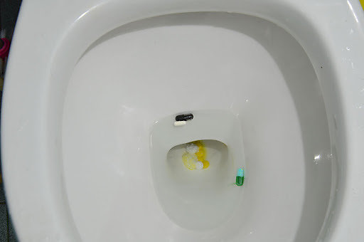  A toilet bowl with pills in it