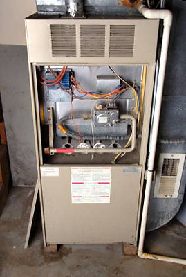Furnace with door open and wires exposed