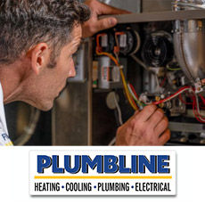 Plumbline heating tech inspecting a furnace