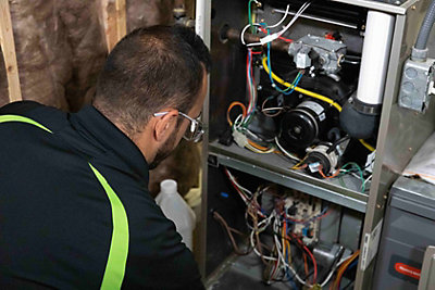 furnace repair technician working