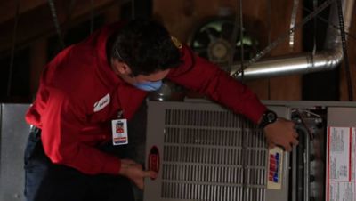 HVAC tech repairing a furnace in Folsom, CA