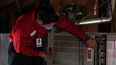 HVAC tech repairing a furnace in Folsom, CA