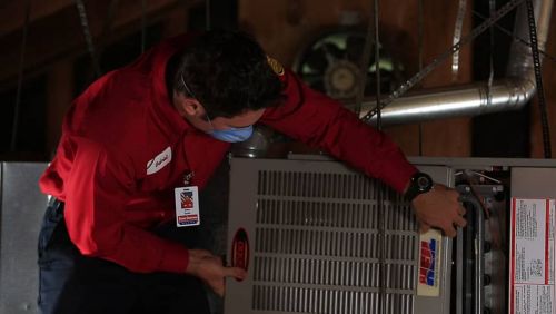 HVAC tech repairing a furnace in Folsom, CA