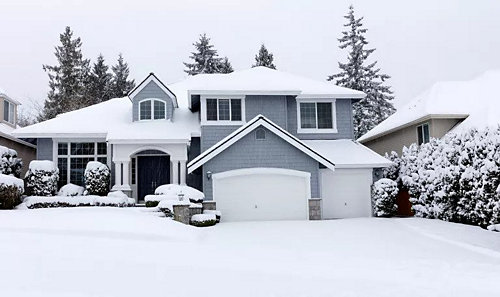 Front view of snow falling on a house
