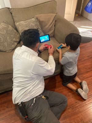 Tech and kid playing video game on Nintendo Switch