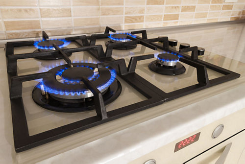 A stove top with blue flames