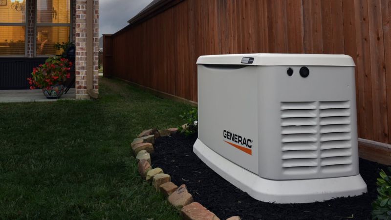 GENERAC Electrical Generator outside by a fence