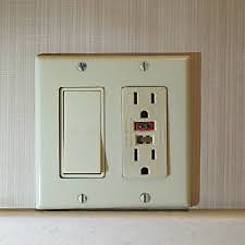 A GFCI outlet installed into a wall.