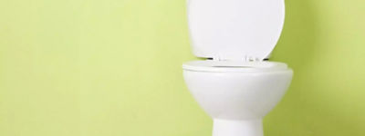 White toilet bowl against a green wall - Williams Comfort Air Heating, Cooling, Plumbing & More