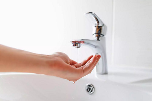 Hand under faucet with low pressure water stream - Mr. Plumber by Metzler & Hallam