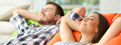 Couple relaxing in a comfortable home - Thomas & Galbraith Heating, Cooling, & Plumbing