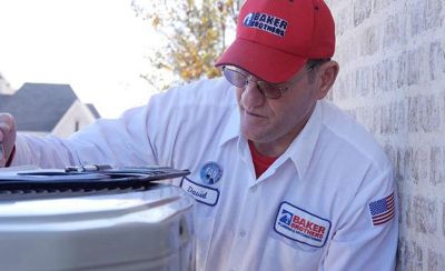 Close up of technician looking at AC unit