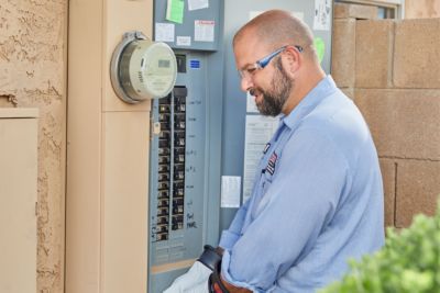 Technician checking out a home's electrical panel