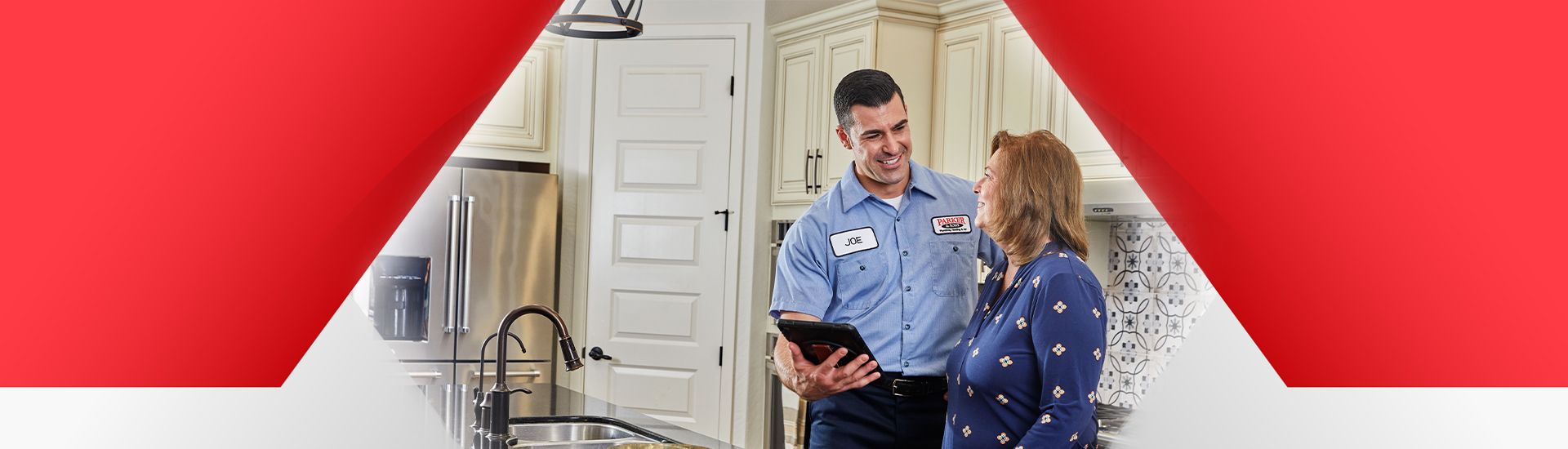 Tech and customer standing in kitchen