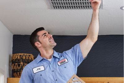 Technician changing air filter