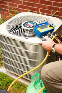 Checking freon levels on air conditioning unit