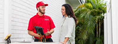 Red Cap worker discussing about Air Conditioning Installation and Replacement Pros in Tampa