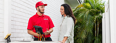 Red Cap worker discussing about Air Conditioning Installation and Replacement Pros in Tampa