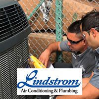 Lindstrom HVAC techs repairing an AC unit