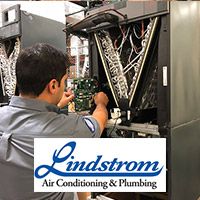 Lindstrom HVAC tech repairing an air conditioning system