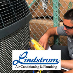 HVAC tech repairing an air conditioning system