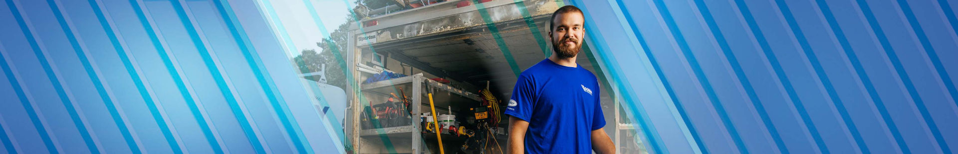 Man posing with a smile in front of his truck