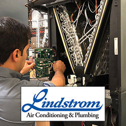 Lindstrom technician repairing an HVAC system