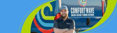 Comfort Wave HVAC technician in front of a service vehicle