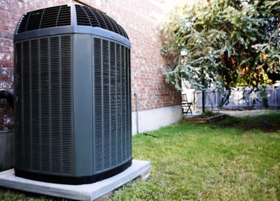 HVAC unit on concrete slab in backyard