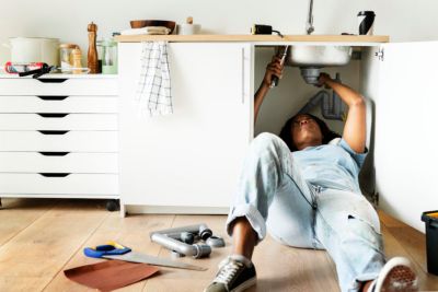 Woman fixing a garbage disposal in a Tampa home