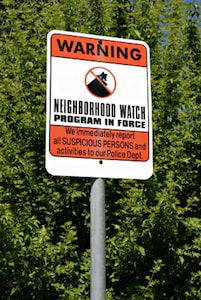 Sign warning about neighborhood watch