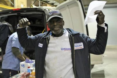 Coolray employee Derrick Peoples holding hands up proud