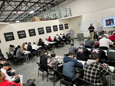 NexGen Employees listening to a speaker