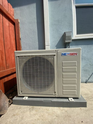 An AC unit connected to a building.