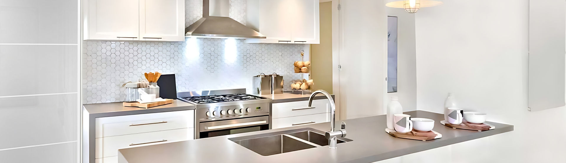 A kitchen with a stove top oven and a sink