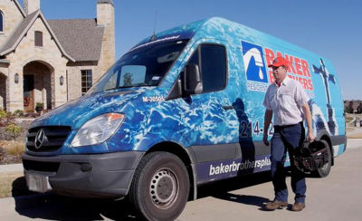 Technician walking by van with toolbag