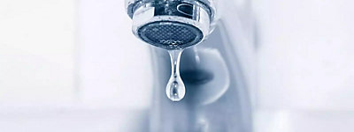 Water dripping from a bathroom faucet - Thomas & Galbraith Heating, Cooling, & Plumbing