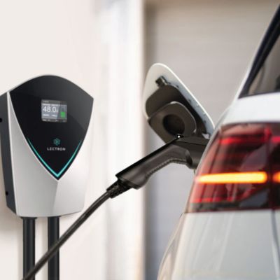 electric car plugged in next to EV charger