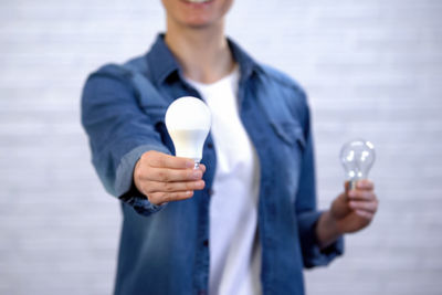 Woman holding light bulbs