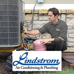 Lindstrom HVAC tech repairing an air conditioner in Boca Raton