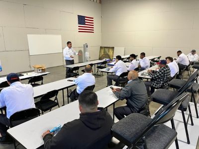 Technicians listening to a speaker