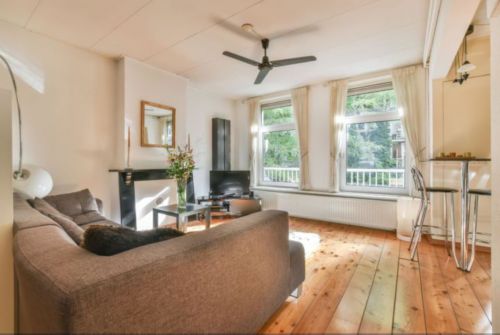 Open living room with hardwood floors and a brown couch