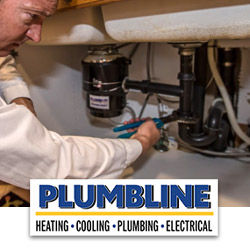 Plumber fixing a leaky kitchen sink drain pipe